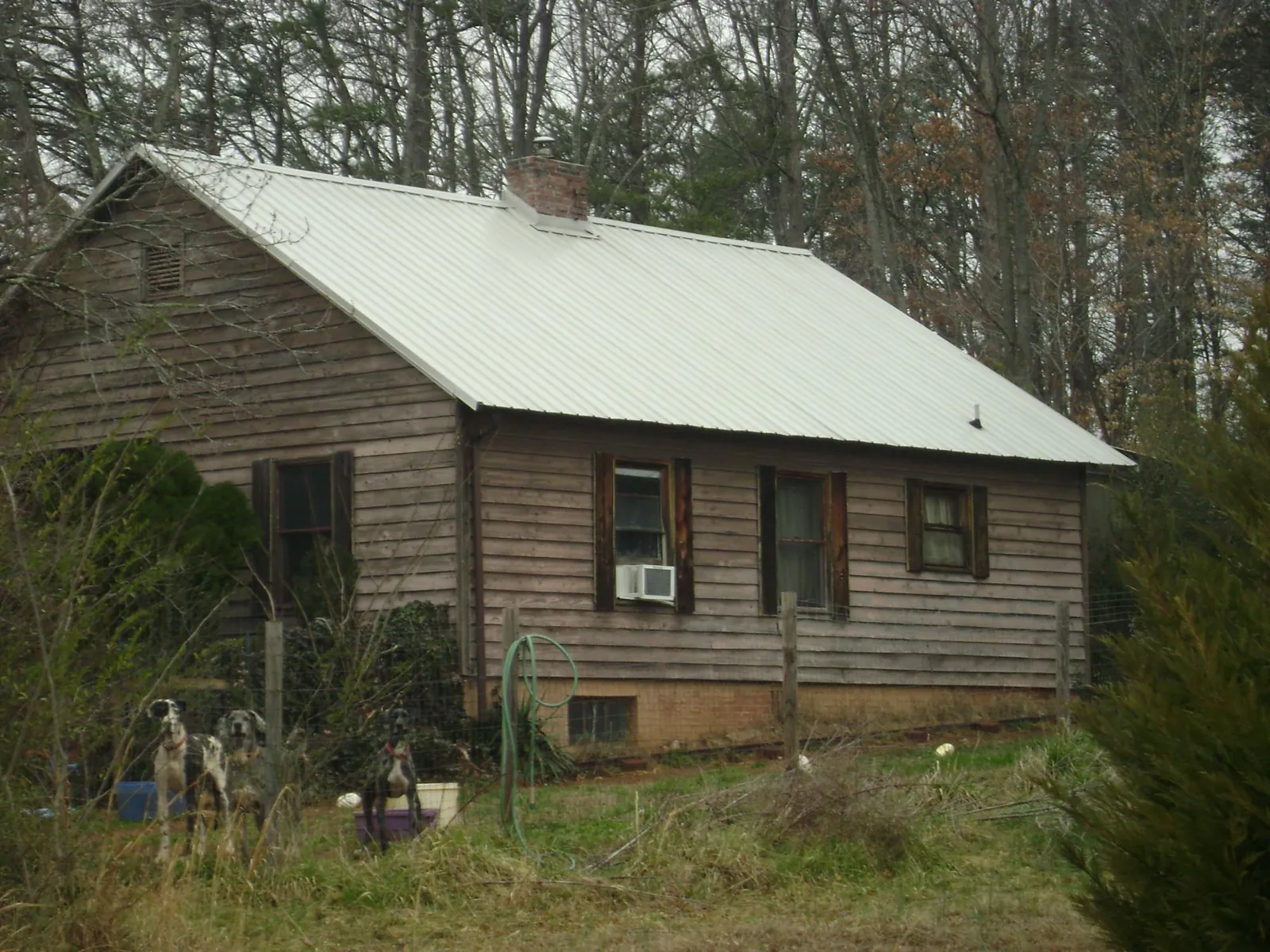 White metal roof on an old wood sided farmhouse, from a Metal Roof Installation job in Cobbtown